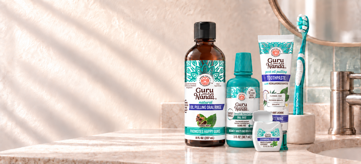 GuruNanda oral-care essentials on a sunlit bathroom vanity.